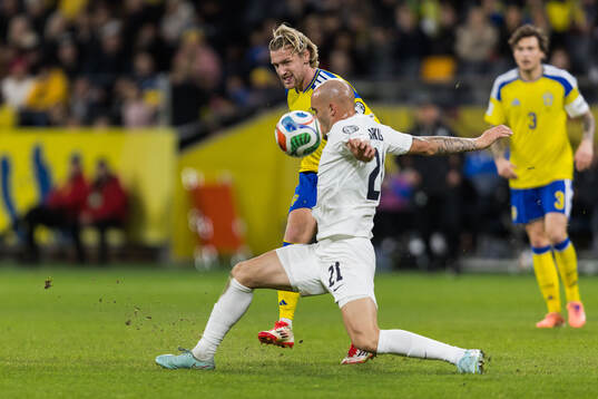 Emil Forsberg of Sweden and Vanja Drkusic of Slovenia