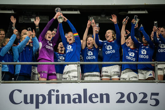 Players of Vålerenga celebrate with the trophy