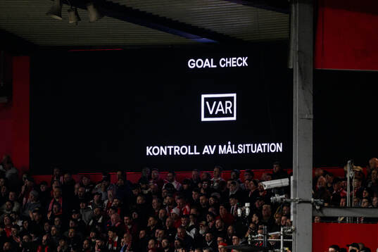 The big screen displays a VAR review message