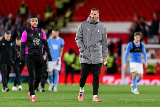 Martin Olsson and goalkeeper Johan Dahlin of Malmö FF look