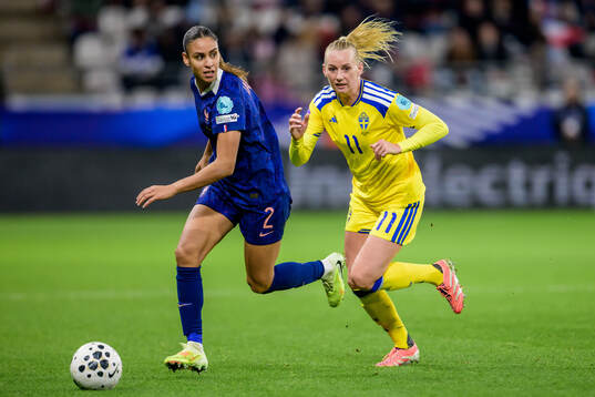 Maelle Lakrar of France and Stina Blackstenius of Sweden