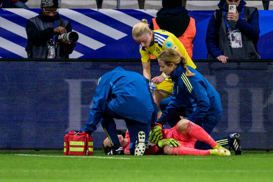 Goalkeeper Jennifer Falk of Sweden receives medical