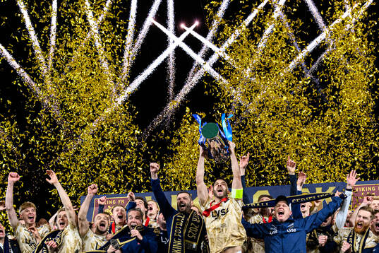 Zlatko Tripic of Viking lifts the trophy together with head