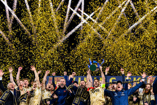 Zlatko Tripic of Viking lifts the trophy together with