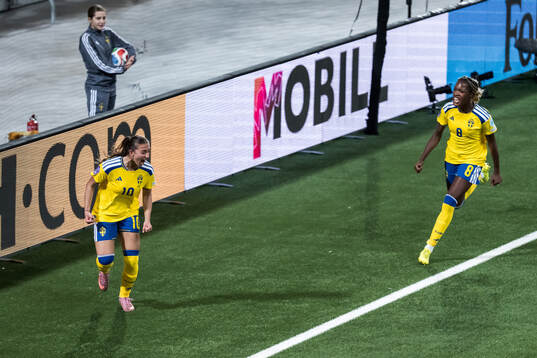 Rosa Kafaji and Evelyn Ijeh of Sweden celebrate