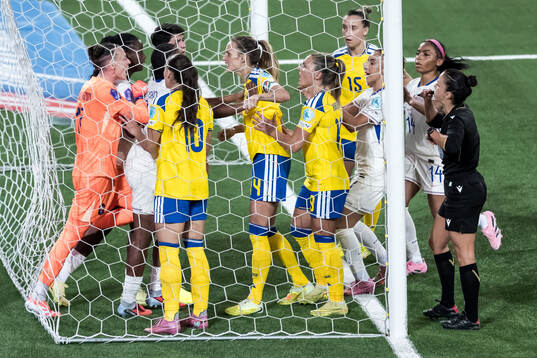 Goalkeeper Pauline Peyraud-Magnin of France argues with