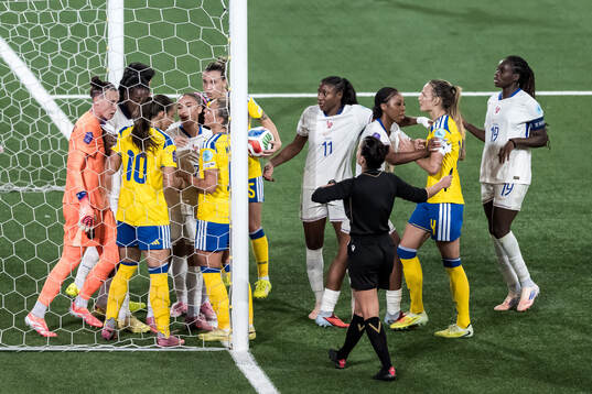 Goalkeeper Pauline Peyraud-Magnin of France argues with