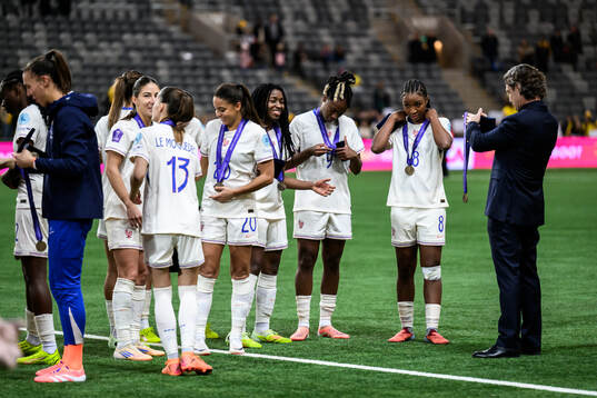 Players of France celebrate with their bronze medals