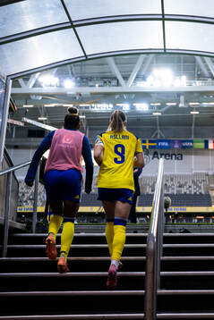Madelen Janogy and Kosovare Asllani of Sweden enter the