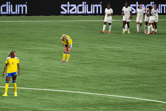 Evelyn Ijeh and Smilla Holmberg of Sweden look dejected