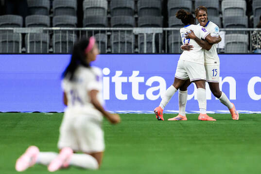 Kelly Gago and Sandy Baltimore of France celebrate