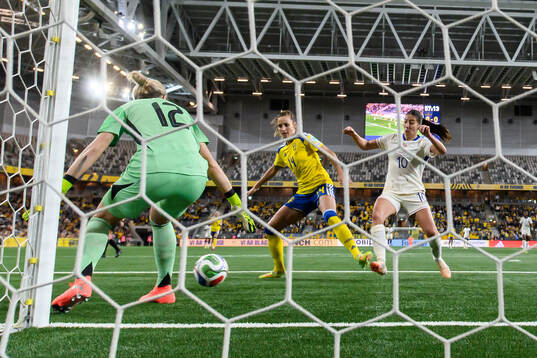 goalkeeper Jennifer Falk and Nathalie Björn of Sweden
