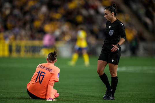 Goalkeeper Pauline Peyraud-Magnin of France and Referee