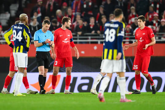 Referee Willy Delajod and Eivind Helland of Brann