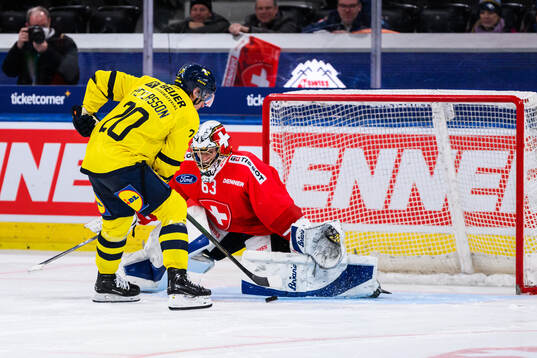 Andre Petersson of Sweden and goalkeeper Leonardo Genoni