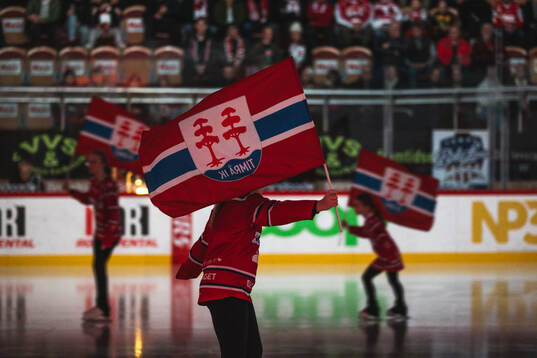Konståkare med timråflagga