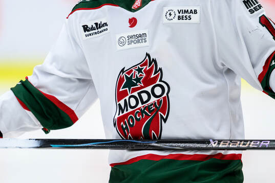Modos klubbmärke på en matchtröja
