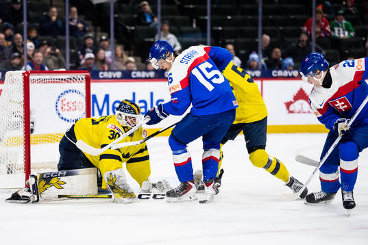 Goaltender Love Härenstam of Sweden against Andreas Straka