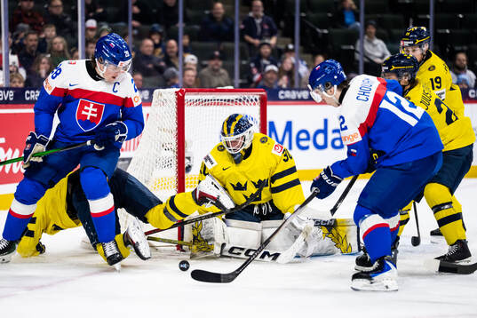 Tobias Pitka and Jan Chovan of Slovakia against goaltender