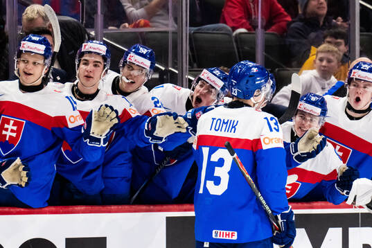 Tobias Tomik of Slovakia celebrates with team mates