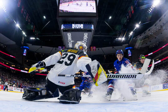 Goaltender Lennart Neisse of Germany and James Hagens of USA