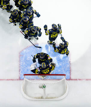 Players of Sweden celebrate together with goaltender Love