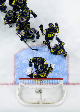 Players of Sweden celebrate together with goaltender Love