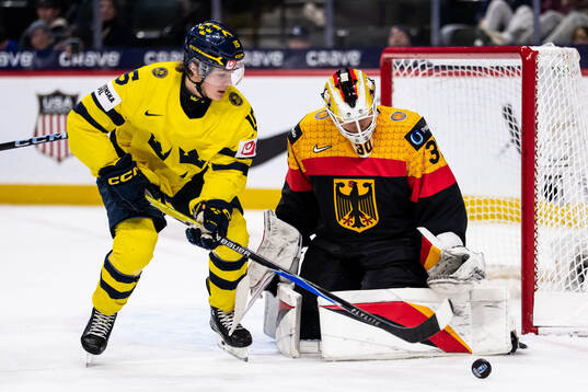 Ivar Stenberg of Sweden and goaltender Lukas Stuhrmann of