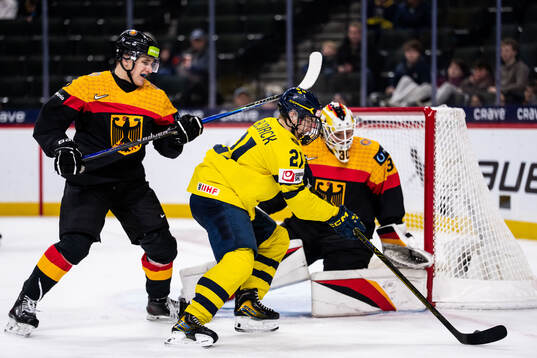 Manuel Schams and goaltender Lukas Stuhrmann of Germany