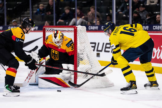 Carlos Handel and goaltender Lukas Stuhrmann of Germany