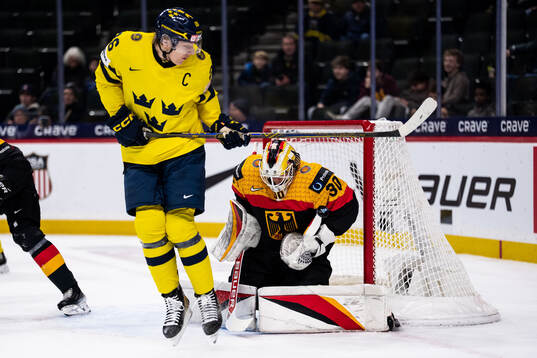Jack Berglund of Sweden and goaltender Lukas Stuhrmann of