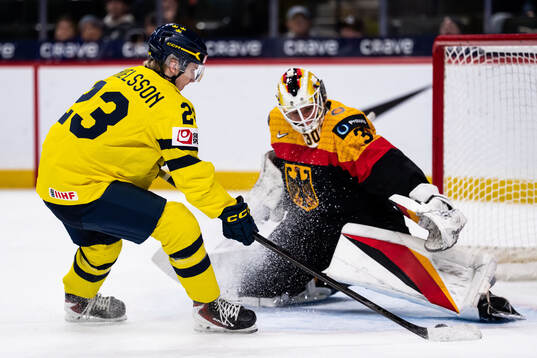 Liam Danielsson of Sweden scores 1-7 behind goaltender