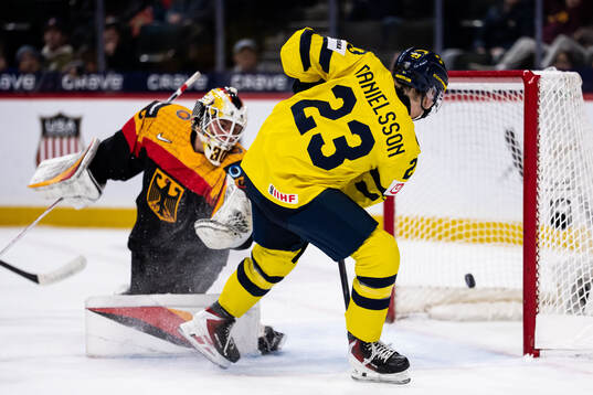 Liam Danielsson of Sweden scores 1-7 behind goaltender