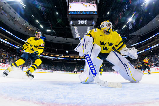 Anton Frondell and goaltender Herman Liv of Sweden