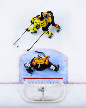 Lucas Pettersson of Sweden challenges goaltender Linus