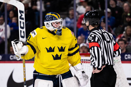 Goaltender Love Härenstam of Sweden and Referee Janne