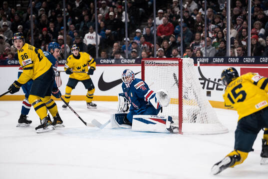Jack Berglund of Sweden and goaltender Nicholas Kempf of