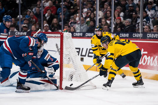 Asher Bernett and goaltender Nicholas Kempf of USA and Ivar