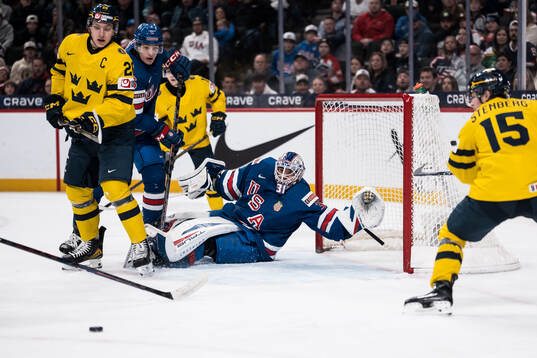 Jack Berglund of Sweden and goaltender Nicholas Kempf of