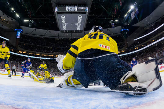 Jack Berglund slides towards goaltender Love Härenstam of