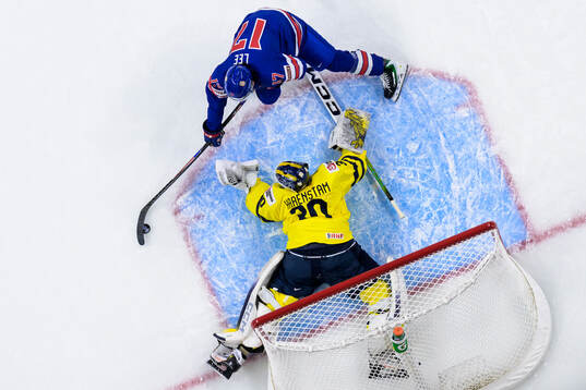Ryker Lee of USA challenges goaltender Love Härenstam of
