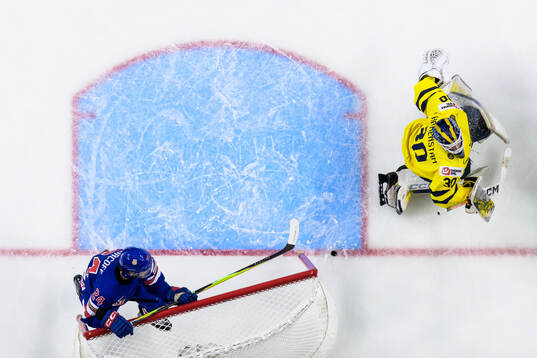 Will Horcoff of USA crashes into the net behind goaltender