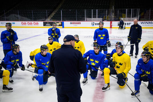 Players of Sweden listen to assistant coach Gereon Dahlgren