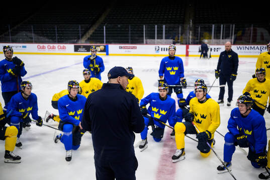 Players of Sweden listen to assistant coach Gereon Dahlgren