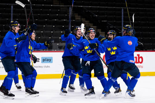 Players of Sweden celebrate at a practice session
