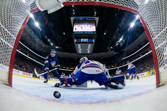 Leo Tuuva of Finland scores the 2-2 goal behind goaltender