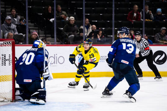Casper Juustovaara Karlsson of Sweden against goaltender