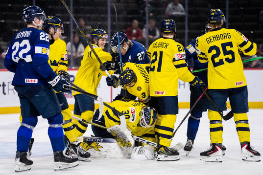 Julius Miettinen of Finland against goaltender Love
