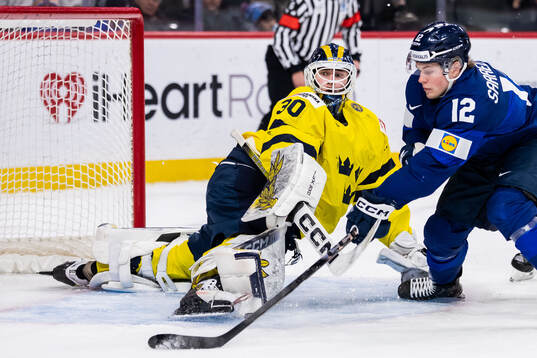 Joona Saarelainen of Finland against goaltender Love