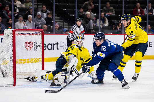 Joona Saarelainen of Finland against goaltender Love